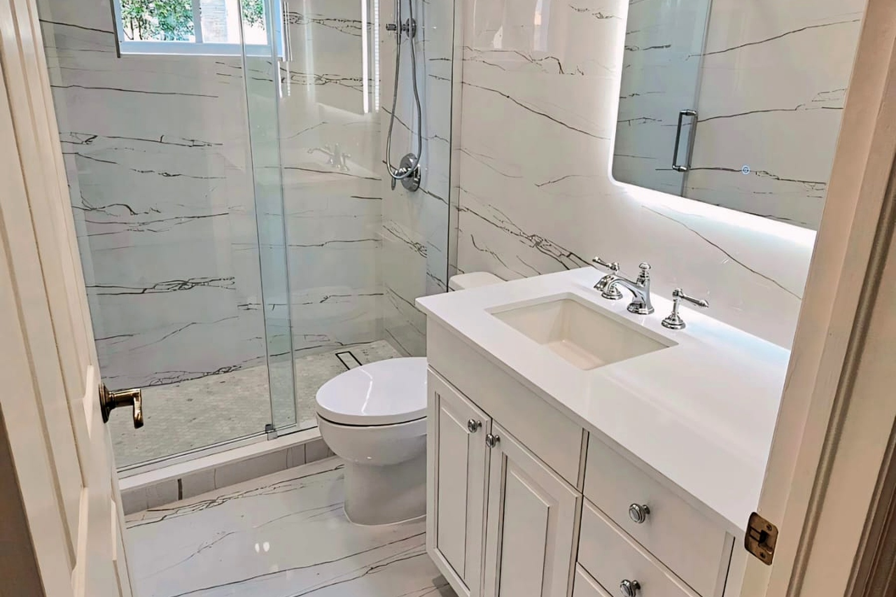 Glass shower with marble-look wall tile